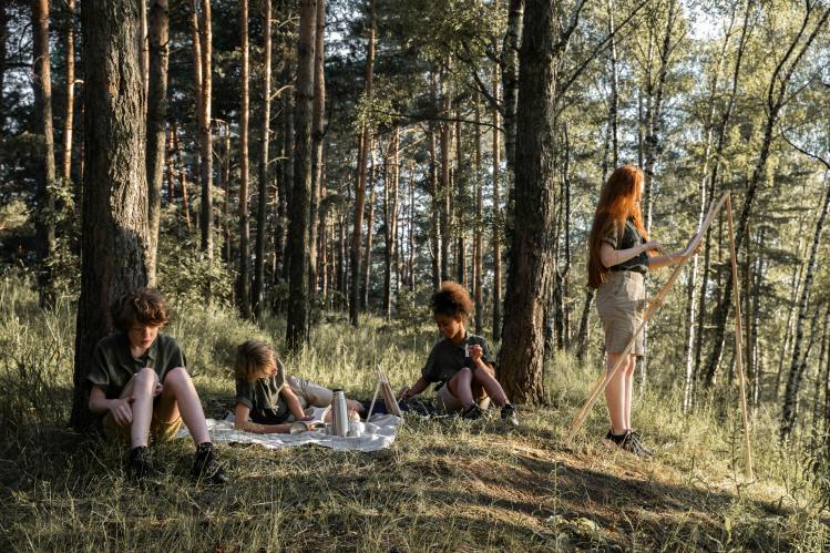 Group of children in forest relaxing